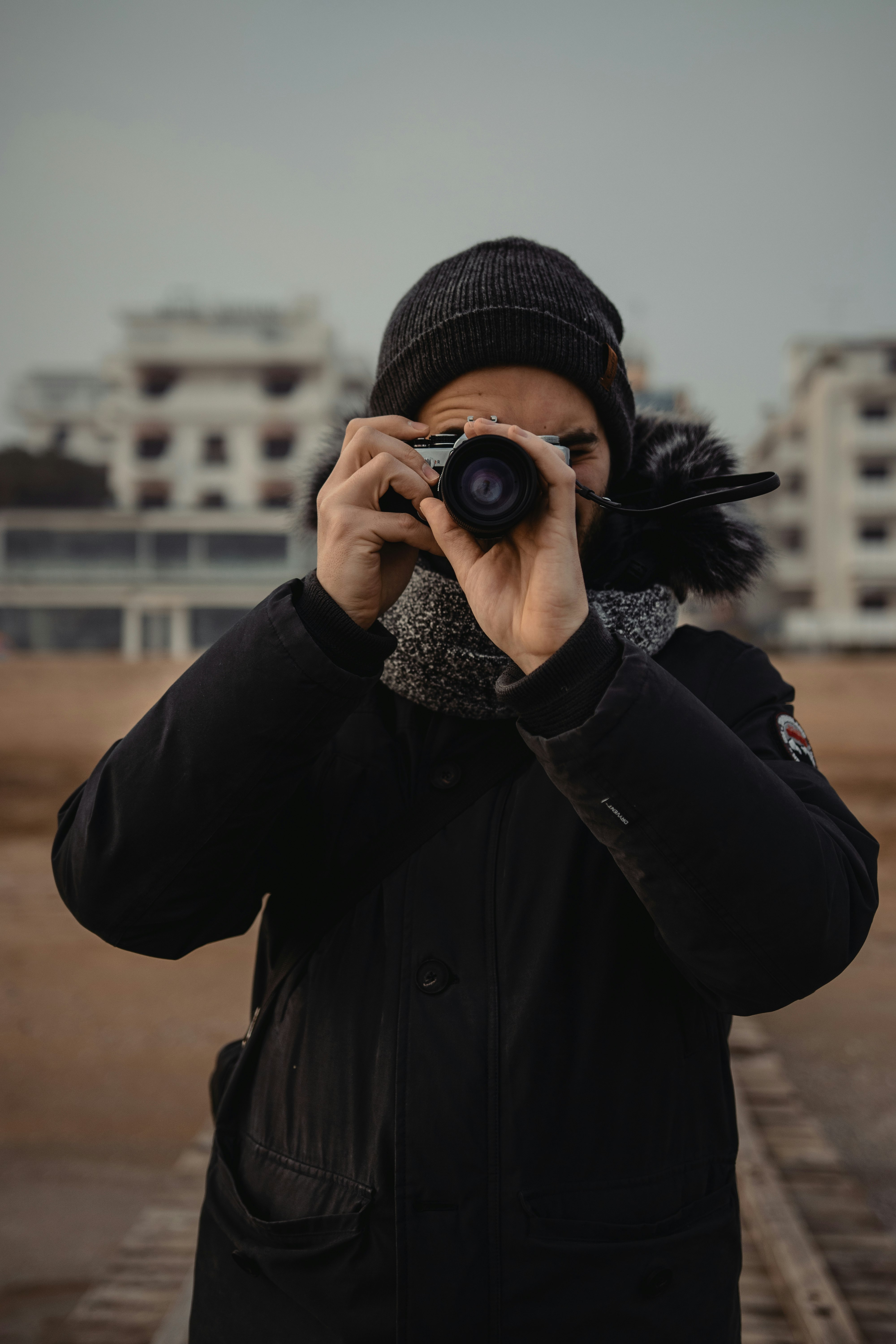 person in black jacket holding camera